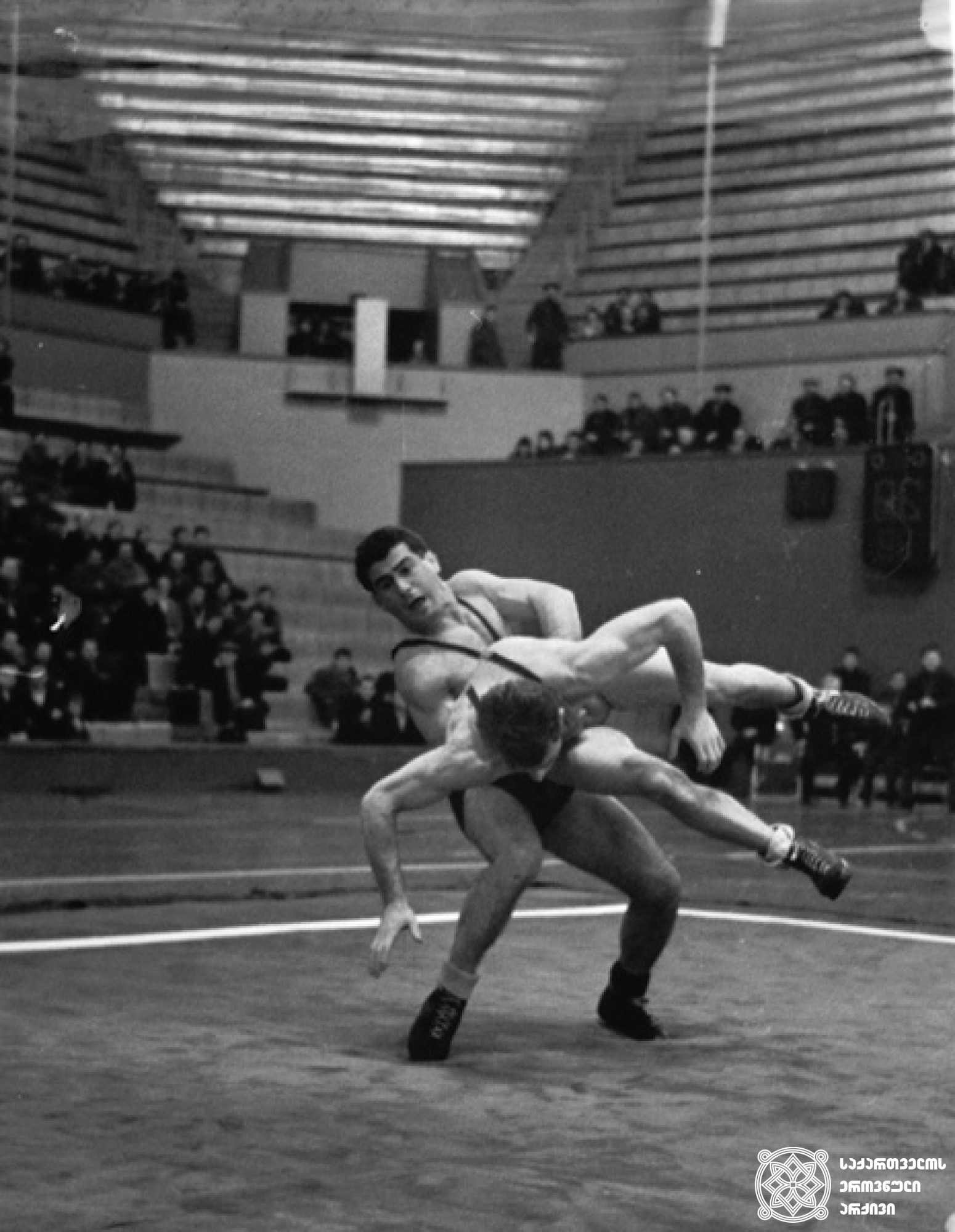 დავით გვანცელაძე. <br>
XVIII ოლიმპიური თამაშების მესამე პრიზიორი ჭიდაობაში (1964 წელი, ტოკიო). <br>
ფოტო საქართველოს ეროვნული ოლიმპიური კომიტეტის ვებგვერდიდან. <br>
David Gvantseladze. <br>
Third-prize winner of the XVIII Olympic Games in Wrestling (1964, Tokyo). <br>
Photo from the web-site of the Georgian National Olympic Committee.